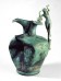 bronze jug with a handle composed of an elegant nude youth